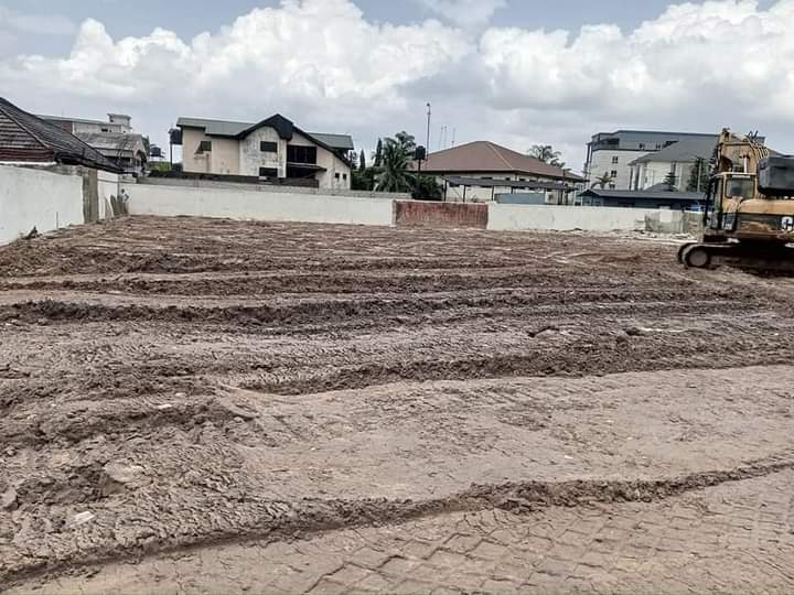 Cleared plot with excavator during land preparation