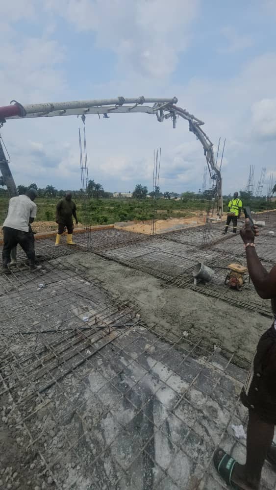 Concrete pump placing slab over steel reinforcement