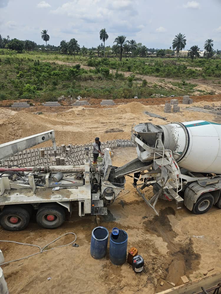 Concrete mixer discharging into a pump truck on site